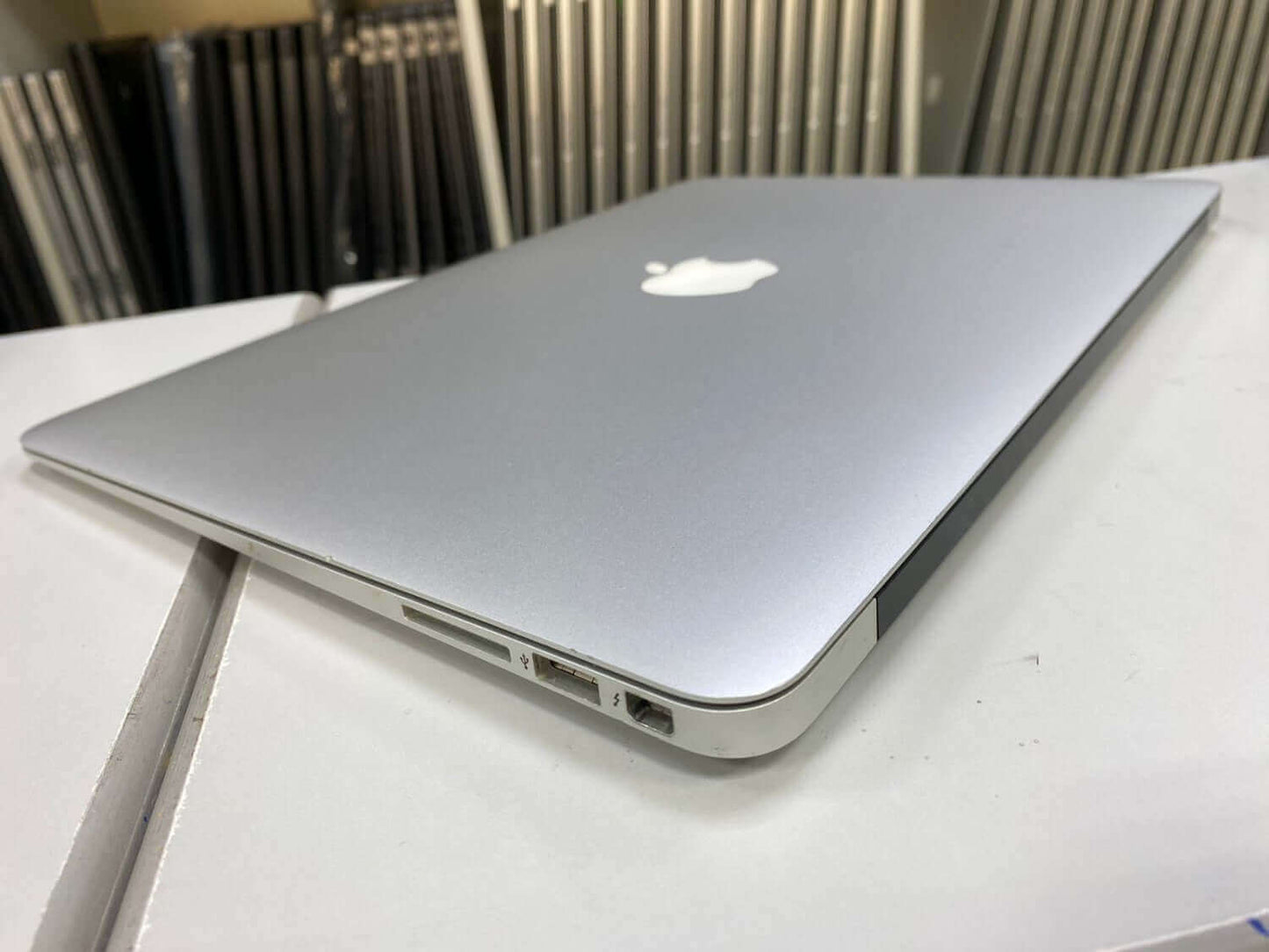 Apple MacBook Air A1466 (2015) in silver, showing side ports and lightweight design, available refurbished for purchase in the UAE.